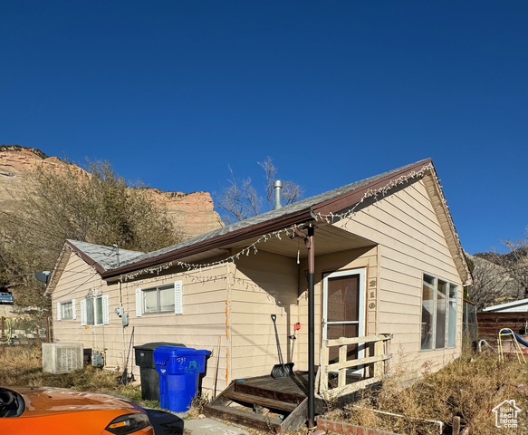 View of front of home featuring central air condition unit