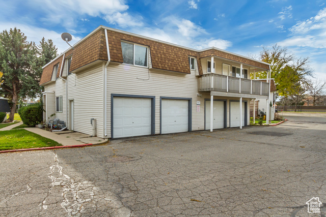 View of front of house with a balcony and a garage