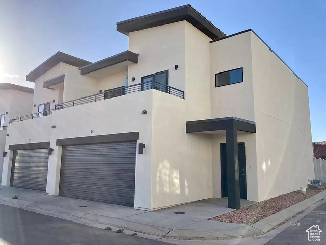 Contemporary home with a balcony and a garage