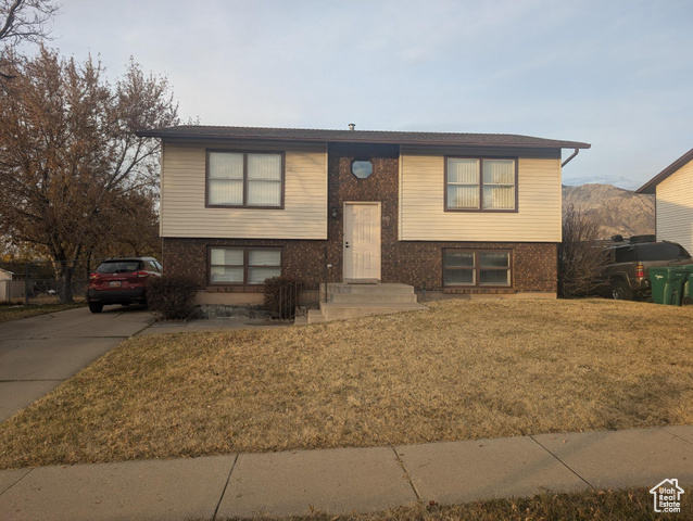 Split foyer home featuring a front lawn