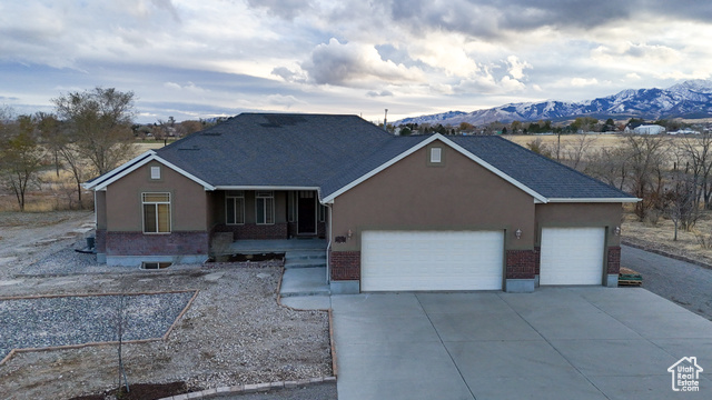 Ranch-style home with a mountain view and a garage