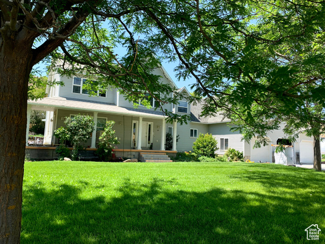 View of front facade featuring a porch and a front yard