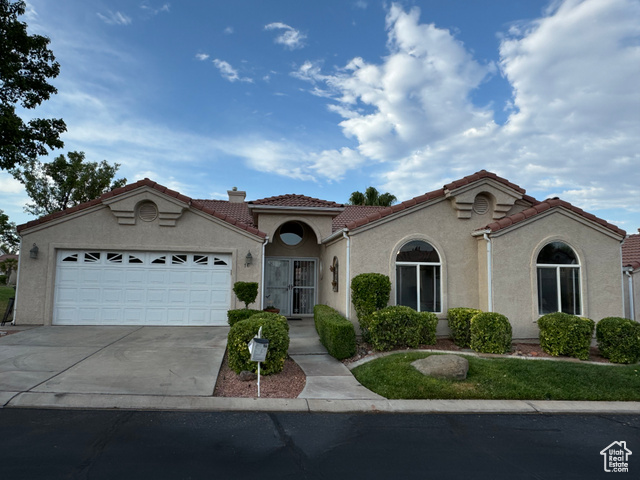 Mediterranean / spanish house featuring a garage