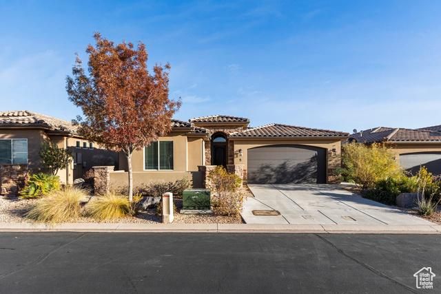 Mediterranean / spanish house featuring a garage