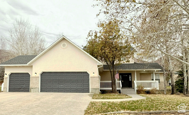 View of front of house with covered porch and a garage