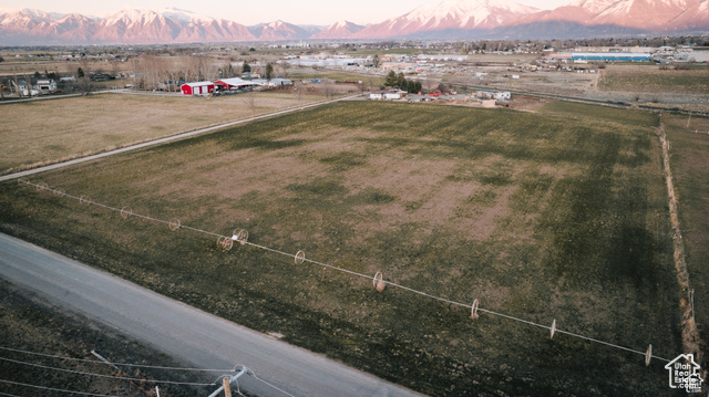 Aerial view at dusk featuring a mountain view and a rural view