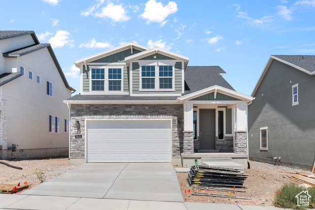 Craftsman house featuring a garage