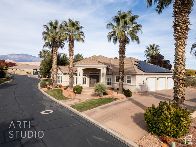 View of front facade featuring a mountain view and a garage