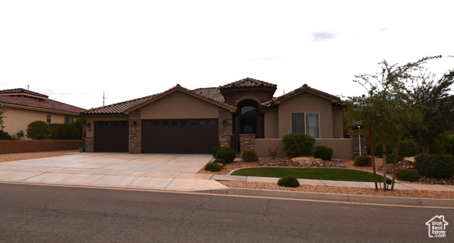 Mediterranean / spanish home featuring a garage