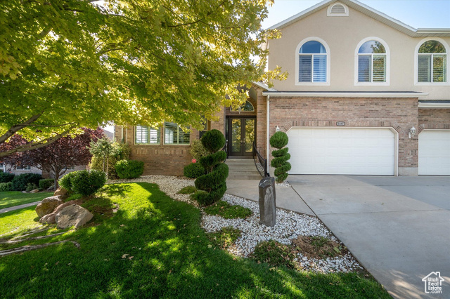 View of front of house with french doors and a garage