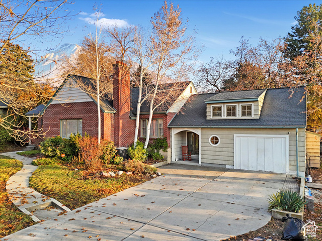 View of front of house with cooling unit and a garage