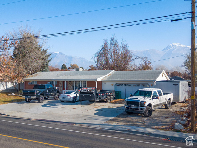 Discover this rare gem in North Lehi-a 1.0-acre horse property with animal rights and incredible potential! Situated in a prime location near Silicon Slopes and I-15, this property offers the perfect blend of tranquility and convenience. Enjoy easy access to local amenities, including Lehi Costco, retail shops, movie theaters, and a wide array of dining options. The expansive lot provides endless possibilities for outdoor activities, gardening, or keeping animals, while the additional 2-car garage offers ample storage for tools and belongings. This property features main-floor living and represents an excellent investment opportunity with subdivision potential. Currently zoned as RA-1, rezoning could allow for two lots, subject to local requirements, including a 15,000 sq ft minimum lot size and additional dedicated water. Please note: the property is being sold AS IS and is currently occupied by tenants. Square footage figures are estimates obtained from county records; buyers are encouraged to obtain an independent measurement. Don't miss this chance to own a rare one-acre property in Lehi-schedule your private showing today!