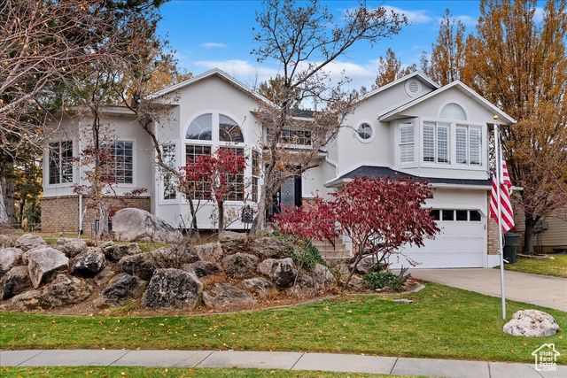 View of front of home featuring a garage and a front yard