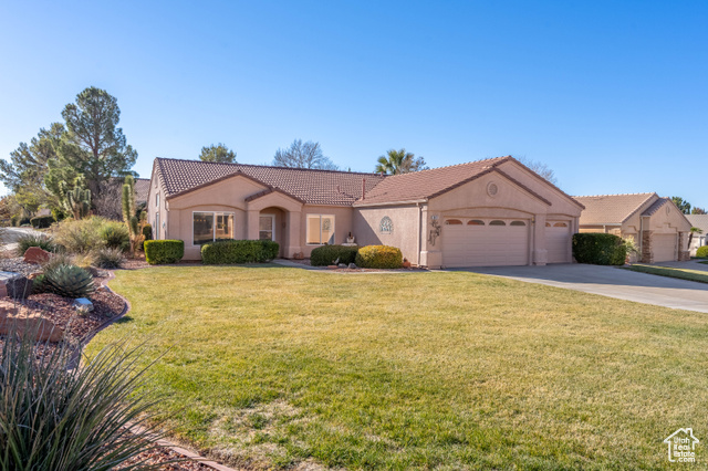 View of front of house featuring a front yard and a garage