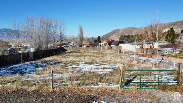 Yard covered in snow with a mountain view