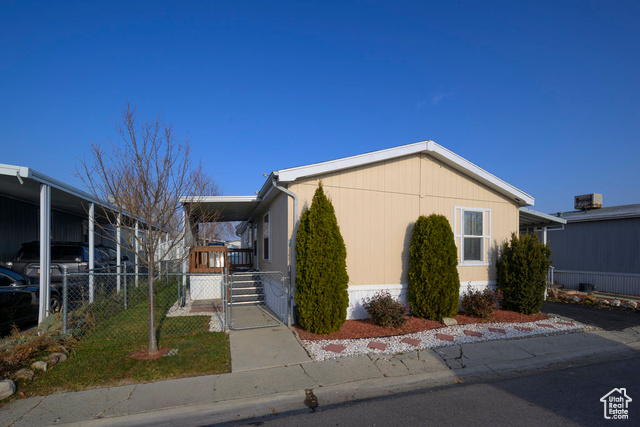 View of property exterior with a carport