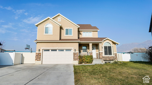 Welcome to your dream home in American Fork! Convenient Location, minutes to shopping, restaurants, frontrunner, library, elementary school. NO Backyard Neighbors. Mountain Views. Fun, inclusive neighborhood with annual "trunk or treat" & July 4th events. Classic rock, stucco, arched window exterior adds a timeless charm. Inviting, covered FRONT PORCH is perfect for sipping morning tea or enjoying a peaceful evening. Home's two-story entrance has a wrought iron staircase, combining elegance and a focal point for guests. Just off the front entrance is a FORMAL LIVING room/ home office. KITCHEN has beautiful solid, knotty alder cabinets with staggered uppers and crown. Vaulted, GREAT ROOM has a craftsman-style mantel, brick hearth, windows with mountain views, color changing can lights controlled by A.I.Dot APP. UPSTAIRS has 4 bedrooms & 2 baths including the primary bedroom which has a vaulted ceiling, mountain views, ceiling fan, en suite bathroom with frosted, glass window for additional privacy. DOWNSTAIRS is partially finished with 1 bedroom, built-in can storage system, and is plumbed for both a future kitchen & bath and space for family room & additional bedroom. BACKYARD fully fenced, sprinklers controlled by B-Hyve APP, there is a concrete, patio area for BBQ, fire-pit, garden area with raspberry bushes, almond tree & fruit trees: fig, pear, elephant- heart plum, peach, cherry, (front yard has bubblegum plum & prune plum trees, and in the front, rocked window well grows rosemary, thyme, dill, sage, lemon-balm, parsley, and a variety of mint) SIDE YARD has a shed and additional poured concrete to store your toys. GARAGE has a side door to yard, 2 overhead storage racks, built-in work countertop /work bench area. ADDED VALUE: 2024 A/C installed, HEPA filter on furnace, 50 gal water tank. Don't miss the chance to make this exceptional house your home! Buyers to verify square footage.