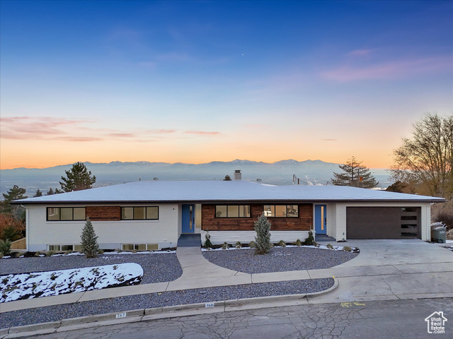 View of front facade featuring a mountain view and a garage