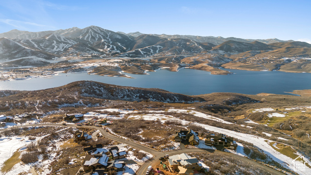 Snowy aerial view with a water and mountain view