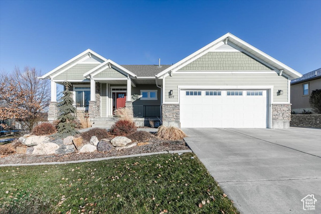 Craftsman-style house featuring a porch and a garage