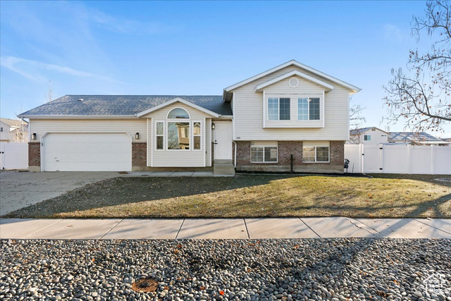 View of front facade with a front yard and a garage