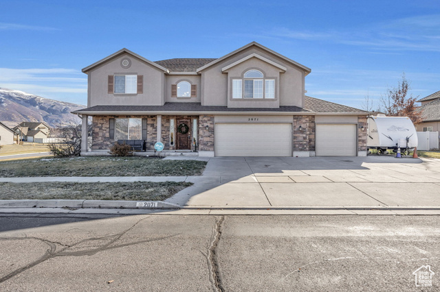 Front facade with a mountain view and a garage