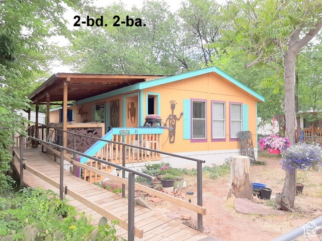 Front view of house featuring a wooden deck