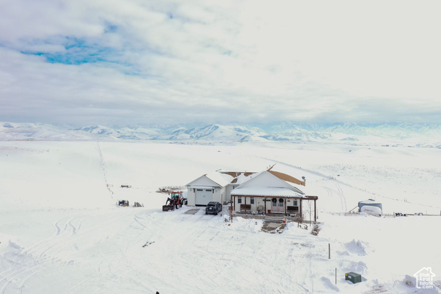 View of front of home with a mountain view and a garage