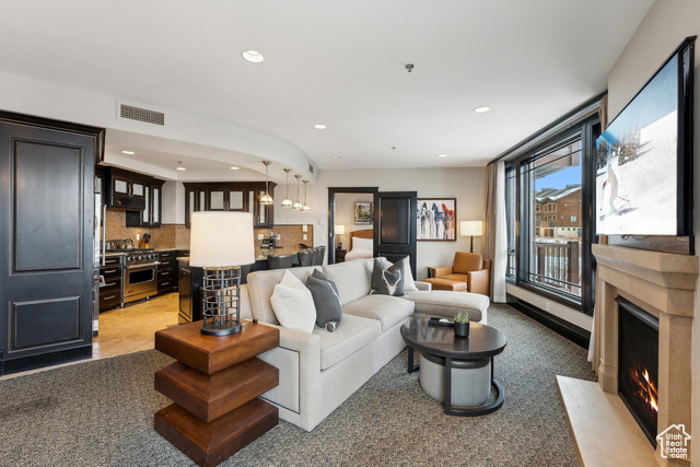 Tiled living room featuring an inviting chandelier