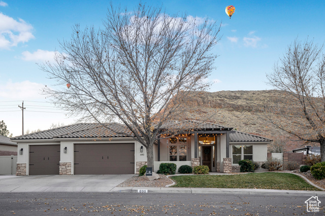 View of front of house with a garage and a front yard