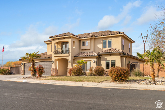 Mediterranean / spanish-style house featuring a balcony and a garage