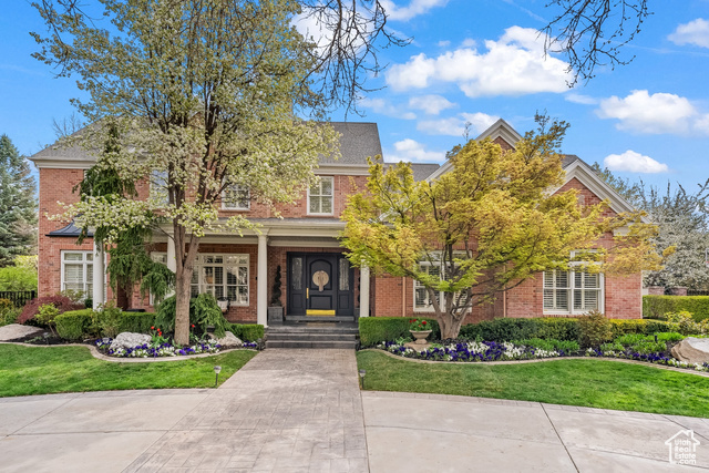 6369 S. Shenandoah Park Avenue offers a graceful and stately two-story home in one of the most picturesque neighborhoods of Salt Lake City, Utah. The consistency of mostly brick custom homes set among the Sycamore tree-lined street reflects this area's high style and desirability, and the warmth of generations, of past traditions and those yet to come. Beautiful verandas front and back, honor the traditional architecture and the circle drive offers an estate feel. Once inside you will be dazzled by the massive entry hall with incredible custom moldings and impressive woodwork. The formal spaces are divine, and the wide-open kitchen and adjoining family room are comfortable. Deluxe appliances, custom Teerlink cabinetry, separate pantry, a workstation, and large center island complete the kitchen. A gorgeous stone fireplace warms the great room. French doors lead to the backyard oasis, where you can entertain in high style. Gleaming pool with fountains, built-in hot tub, pool house with sauna and outdoor kitchen offering plenty of space for lounging and dining. The main floor primary suite is a vaulted retreat in a private wing with luxurious bath, dual vanities, spa tub, and detailed dual wardrobes. Three more bedrooms, which offer the same custom moldings, high ceilings, and two additional baths both outfitted in Calcutta marble tile and a large rec space, perfect for the home gym or the little ones, complete the upper floor. The lower level is incredible with delightful bedrooms, two stunning designer baths, an amazing library/office with beautiful built-in, and a wonderful family room with a wet bar. Tons of storage and fully built-out closets are throughout. A three-car epoxy floored garage offers the ability to charge your electric vehicle. The central location offers easy freeway access to downtown and world-class outdoor recreation in the nearby Cottonwood Canyons. This home has been professionally upgraded throughout the years. Perpetually loved by all. The setting is beautiful and sure to be at the top of your list. With the quality of craftsmanship, the abundant amenities, and the location, this home represents an incredible VALUE. Your invitation awaits.