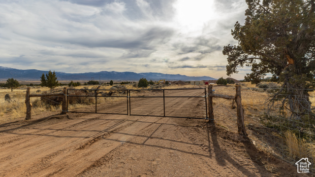 View of gate with a mountain view and a rural view