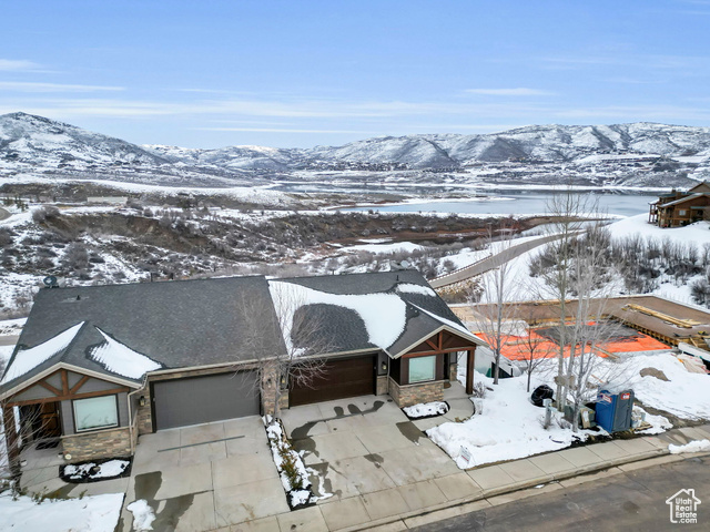 Perched on the picturesque landscape of the Jordanelle Reservoir, this residence offers a seamless blend of luxury and comfort. As you step inside, relax and enjoy views of the pristine waters and majestic mountains, creating a tranquil atmosphere that defines the essence of lakeside living.  The interior exudes a blend of modern elegance and mountain charm. High-end finishes, an open-concept layout, and carefully curated details create a welcoming ambiance for both relaxation and entertaining.  You will find this is more than just a home; it's a lifestyle tailored for those who appreciate the serenity of lake views and the convenience of modern living. Elevate your vacation home experience and seize the chance to make lasting memories in this exquisite lakeside retreat.  This location provides convenient access to the area's recreational activities, from boating on the lake to exploring nearby hiking and biking trails, and world class skiing. Whether you're seeking a tranquil weekend retreat or a full-time residence, this property offers an opportunity to embrace the joys of lakeside and mountain living.