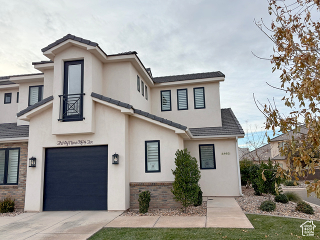 View of front facade featuring a garage