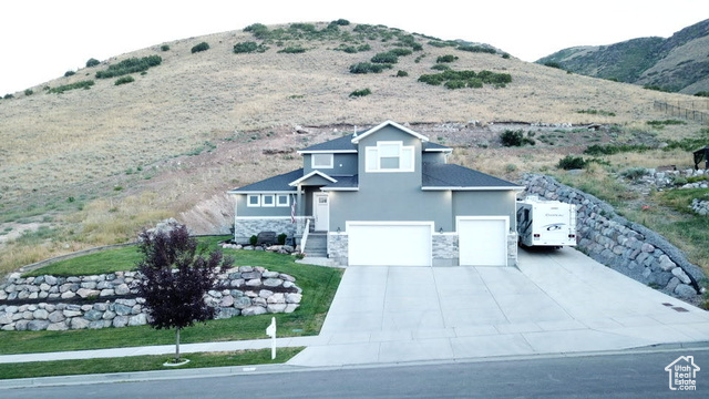 You don't want to miss this "Gorgeous" home, perfectly situated on a .67-acre lot in a peaceful Herriman neighborhood. Enjoy breathtaking panoramic views of the entire valley from the front yard, while the backyard offers unparalleled privacy with direct access to the mountains-no backyard neighbors, ever. This home boasts 6 spacious bedrooms, 3.5 baths, two kitchens, two laundry rooms, and an abundance of living space across three levels. The main floor features a luxurious master suite complete with a huge walk-in closet and master bath, a bright and open living room, a gourmet kitchen with a massive pantry, a mudroom, a laundry room, and a convenient half bath. Upstairs, you'll find three additional bedrooms, a full bathroom with a separate door for showering, and a versatile loft space. The fully finished basement is a highlight, offering a complete apartment with its own entrance and driveway, two large bedrooms a bathroom, a full second kitchen, a living room, a laundry room, and 3 storage areas. Additional features include a 3-car garage, endless storage throughout the house, ceiling fans in each room, and a huge RV Pad. Schedule a showing and come check it out!