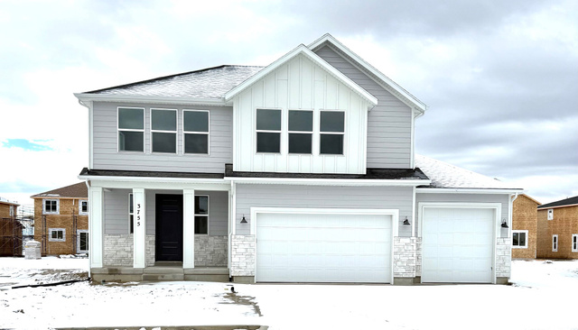 View of front of property featuring a garage