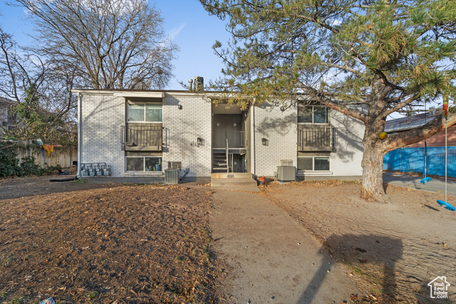 View of front of house with central AC