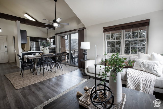 Dining room with ceiling fan, dark hardwood / wood-style flooring, and lofted ceiling