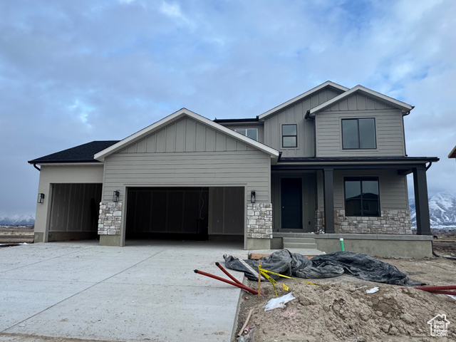 View of front of home featuring a porch and a garage