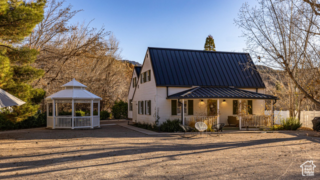 View of front of house with covered porch and a gazebo