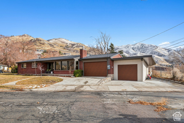 Single story home with a mountain and valley views and a garage