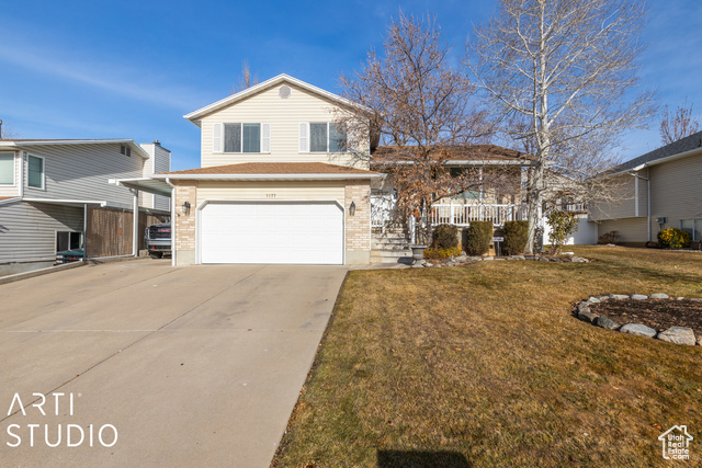 Split level home with a front yard and a garage