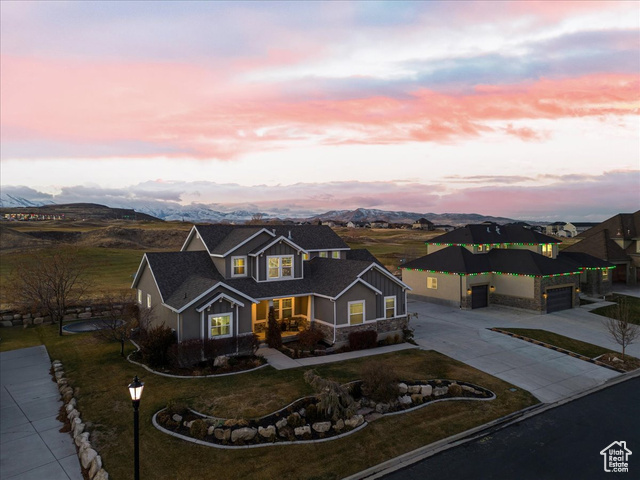 View of front of property featuring a mountain view and a garage