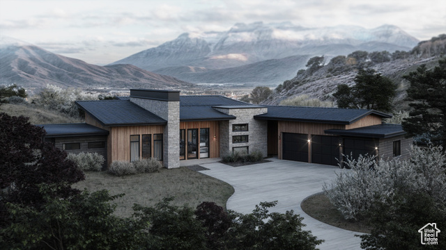 View of front of home featuring a mountain view and a garage