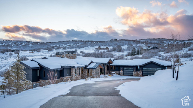 View of front facade with a mountain view and a garage