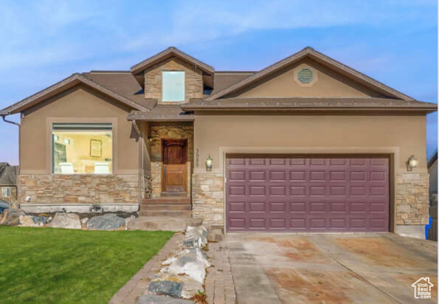 View of front of house with a front lawn and a garage