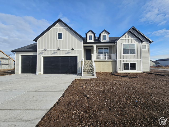 View of front of house featuring covered porch and a garage