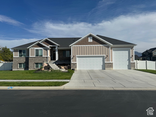 View of front of home featuring a garage and a front lawn