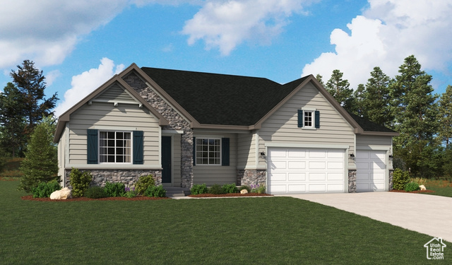 View of front of home featuring a front yard and a garage